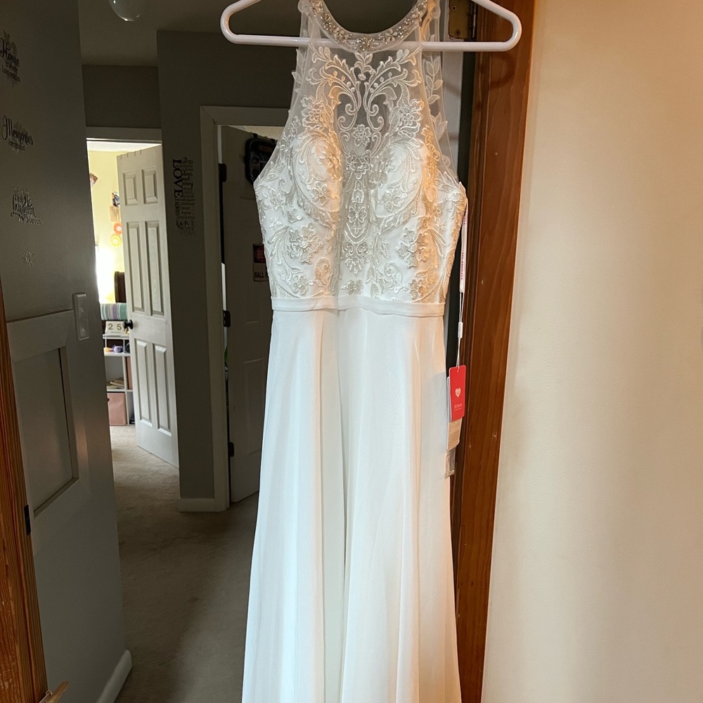Gorgeous J.J.’s House long, white prom dress with silver accents at the top.